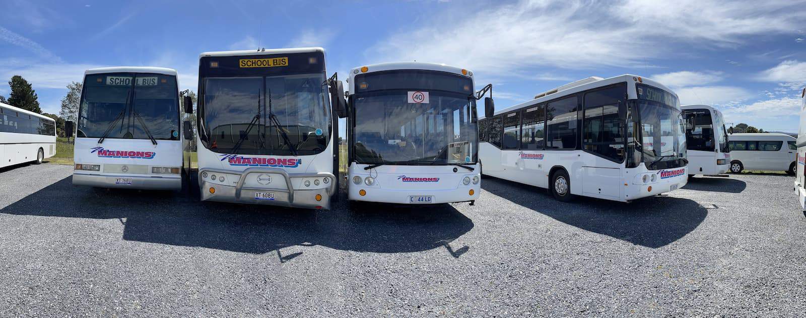 Photo of Manions' Coaches buses on side of road